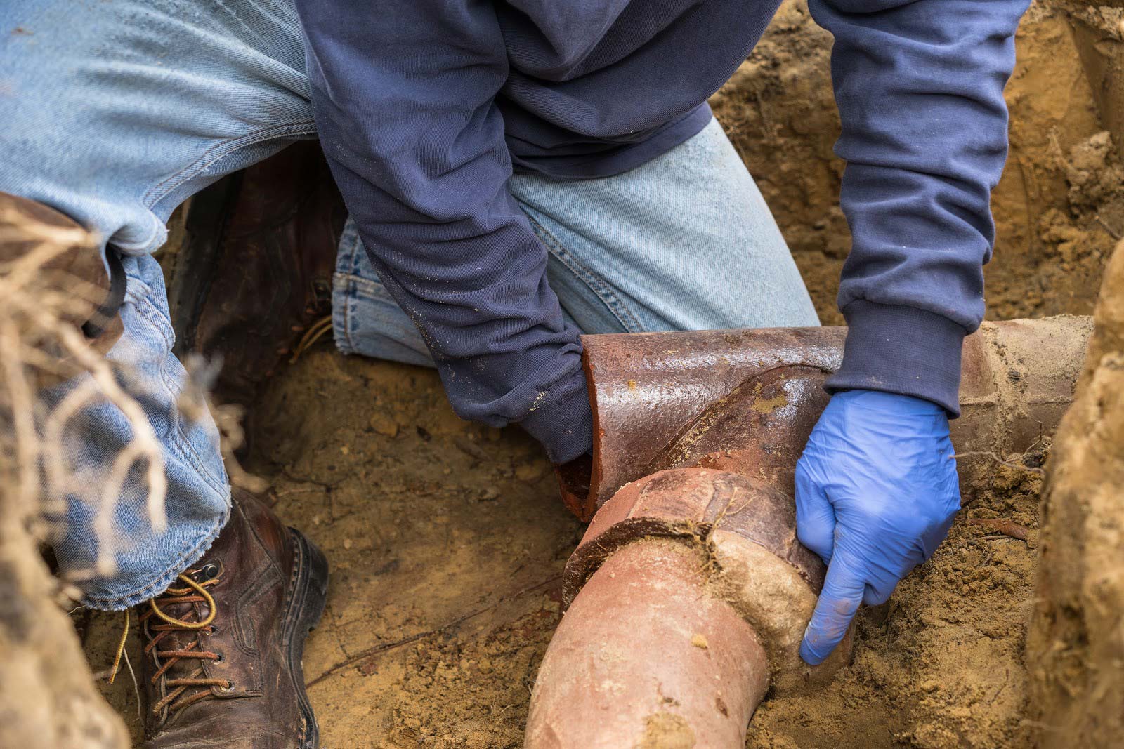 worker cleaning sewer pipe